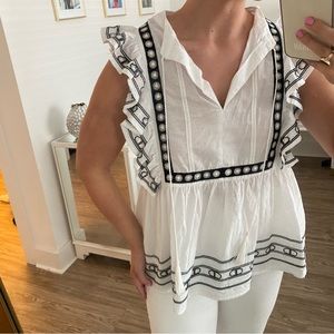 White ruffled top with black embroidery